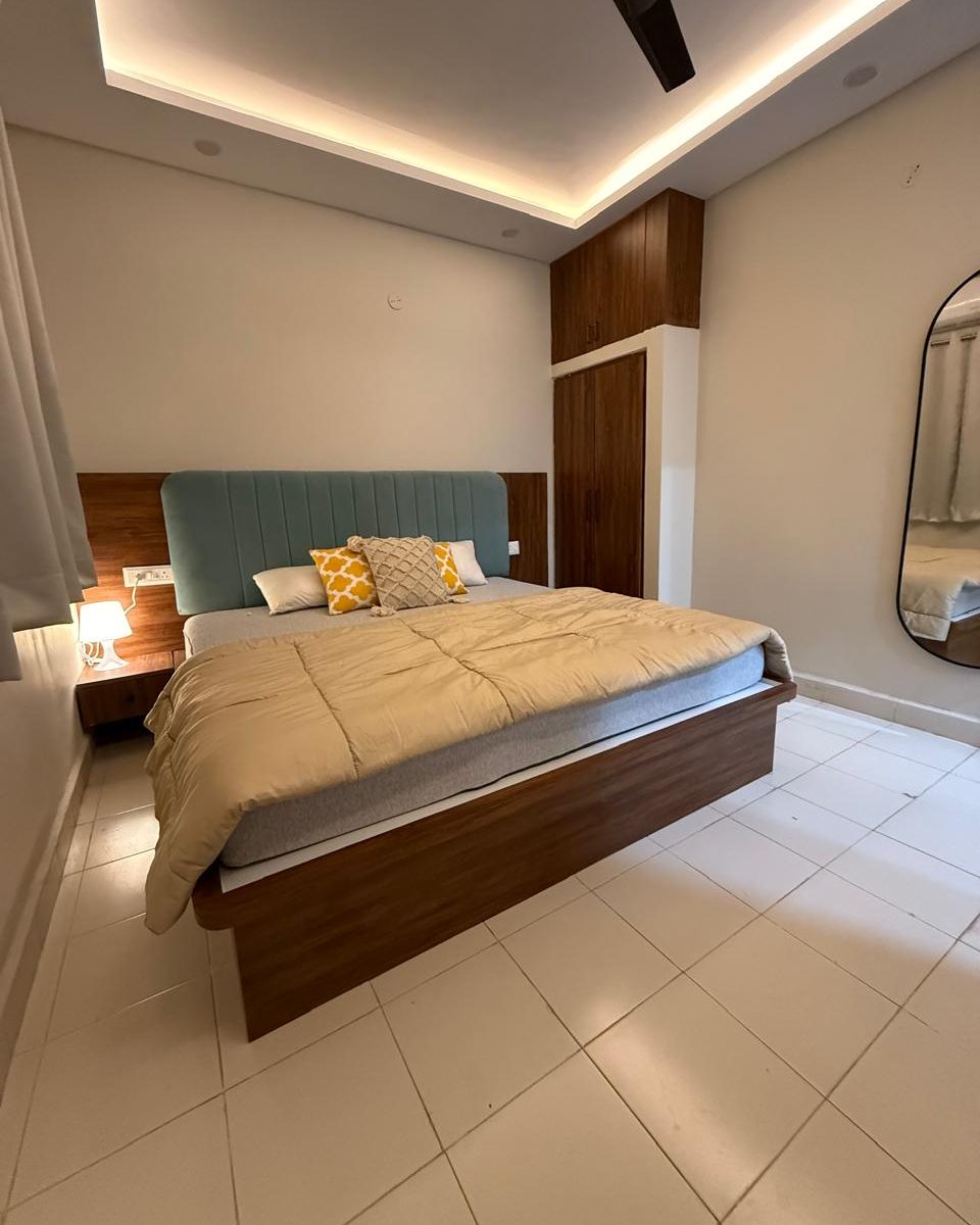 A bedroom with an upholstered headboard