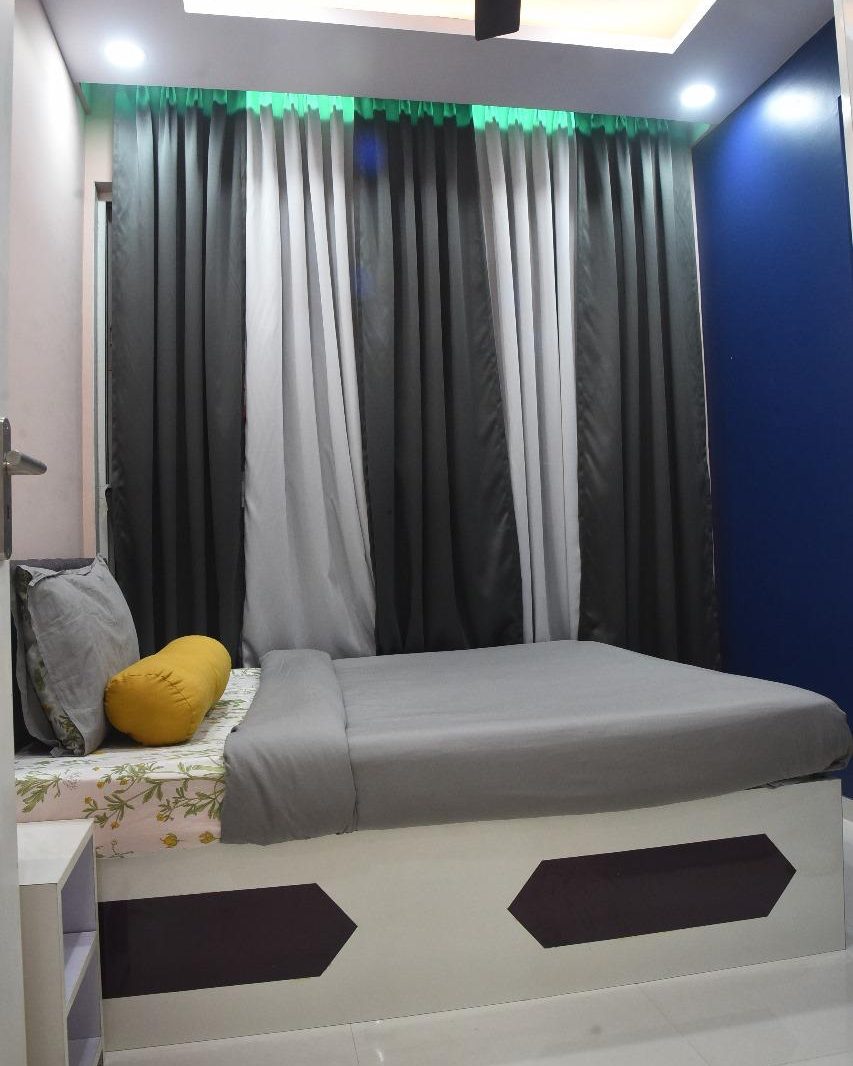 Bedroom with a blue feature wall in HSR Layout