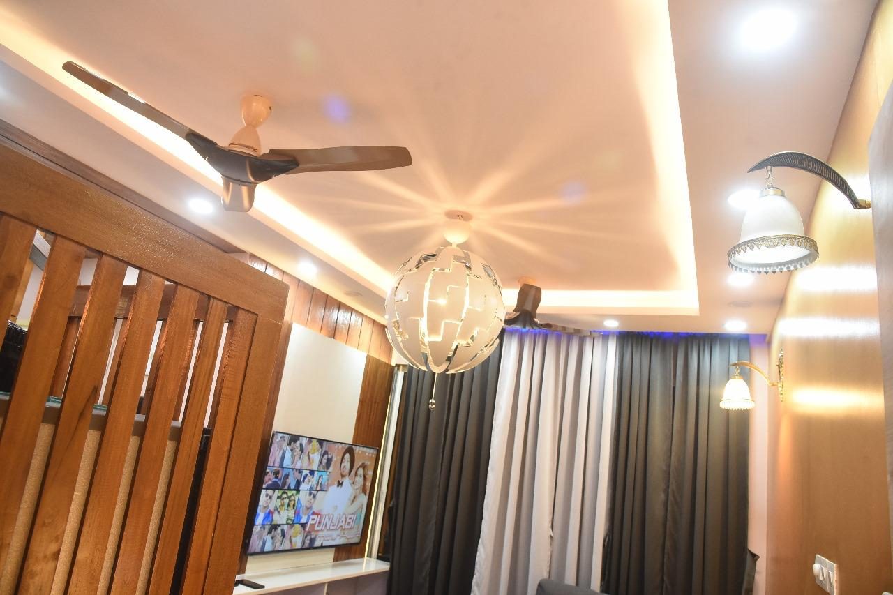 Living room with a wood ceiling and pendants in Indiranagar