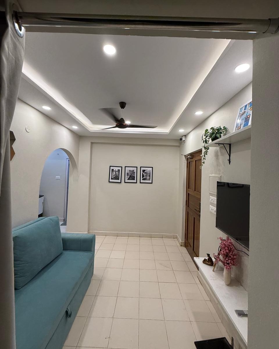 Living room with a wall mounted TV in Whitefield